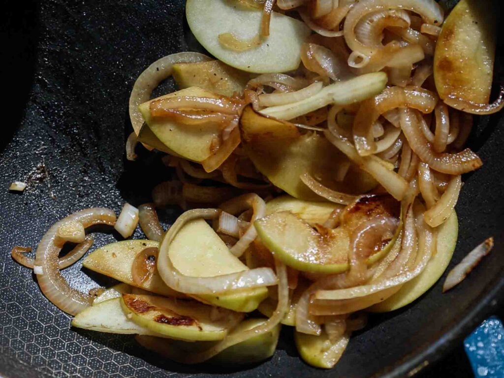 onions and apples starting to brown in pan